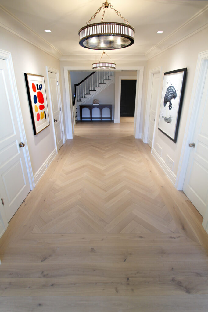 Clover Prime Grade Herringbone Installed Next to Rustic Grade Plank Wood Flooring